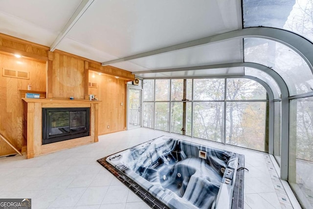 living room featuring vaulted ceiling with beams and wood walls