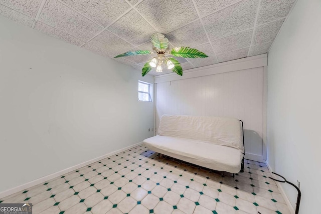 unfurnished room featuring a drop ceiling and ceiling fan