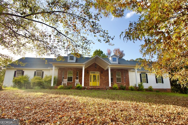 new england style home with covered porch