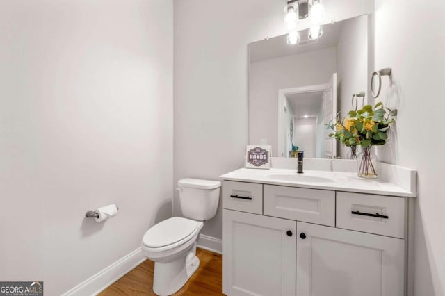 bathroom featuring hardwood / wood-style floors, vanity, and toilet