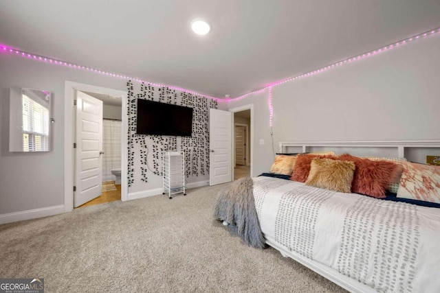 carpeted bedroom featuring ensuite bath