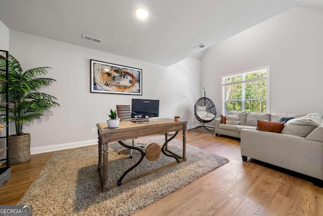 office area with hardwood / wood-style flooring and lofted ceiling