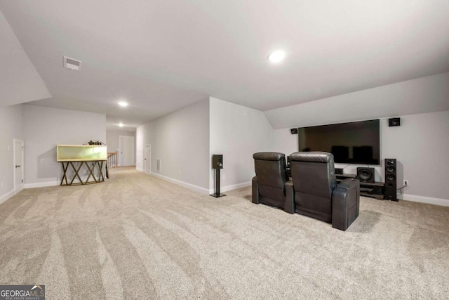 cinema with light carpet and vaulted ceiling