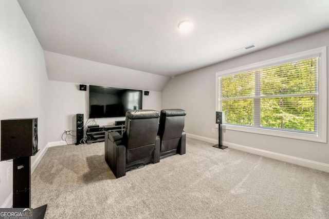 cinema featuring light carpet and vaulted ceiling