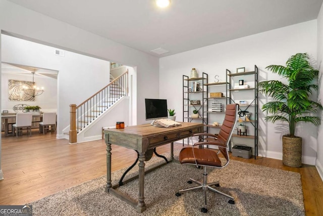 office space with hardwood / wood-style floors and an inviting chandelier