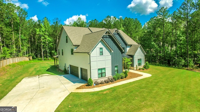 view of side of home featuring a garage and a yard