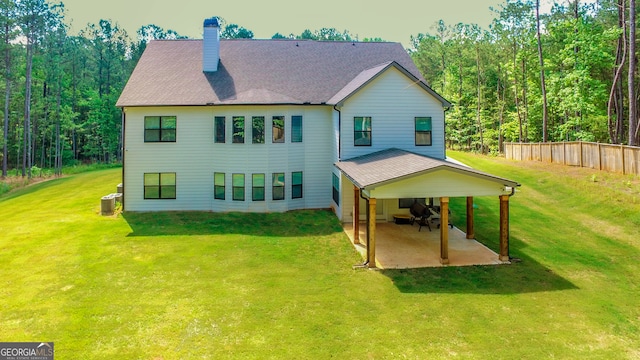 rear view of property with a yard and a patio area