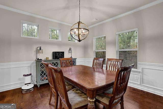 dining room with dark wood-style flooring, wainscoting, and crown molding