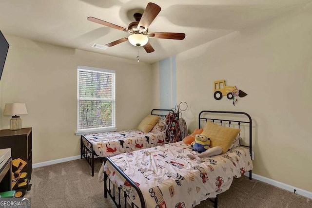 bedroom featuring light carpet, baseboards, visible vents, and ceiling fan