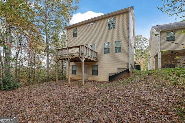 back of house featuring a wooden deck and central air condition unit