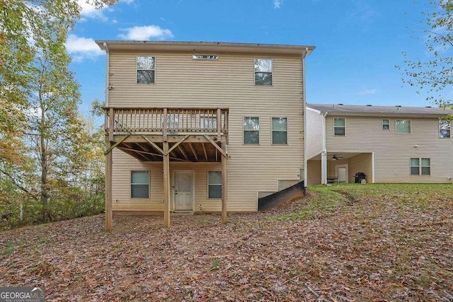 back of property featuring a wooden deck