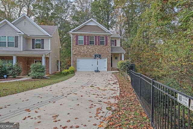 view of front of property featuring a garage, brick siding, fence, and driveway