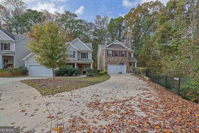 view of front of house with a garage, fence, and driveway