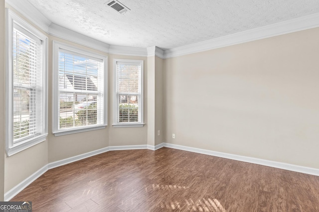 unfurnished room with ornamental molding, wood-type flooring, and a textured ceiling