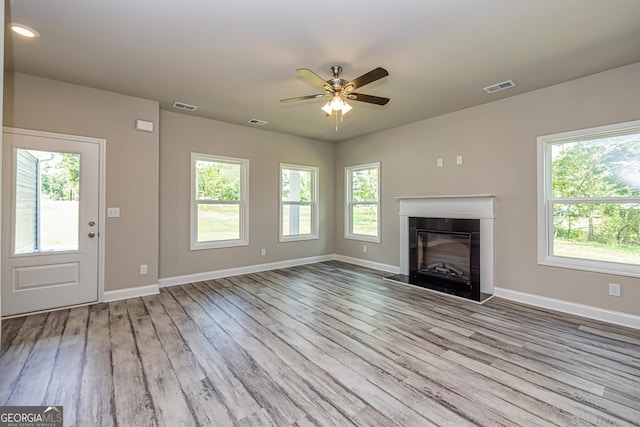 unfurnished living room with ceiling fan and light wood-type flooring