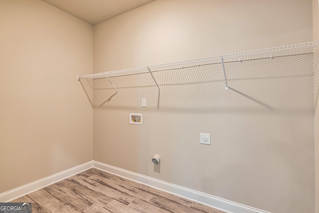 clothes washing area with hardwood / wood-style floors, washer hookup, and hookup for an electric dryer