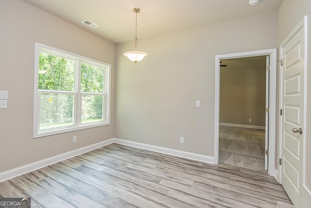 spare room featuring light hardwood / wood-style flooring