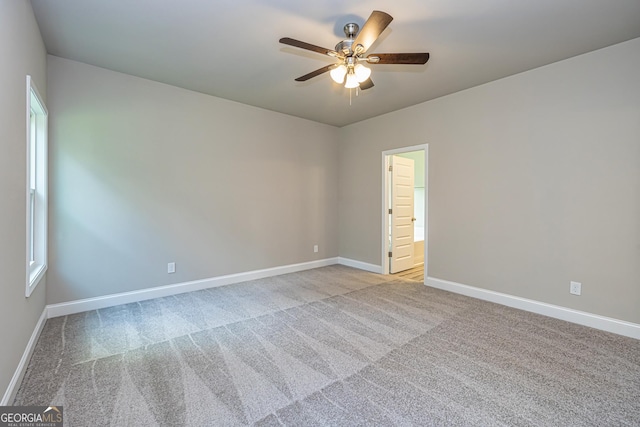 carpeted empty room featuring ceiling fan