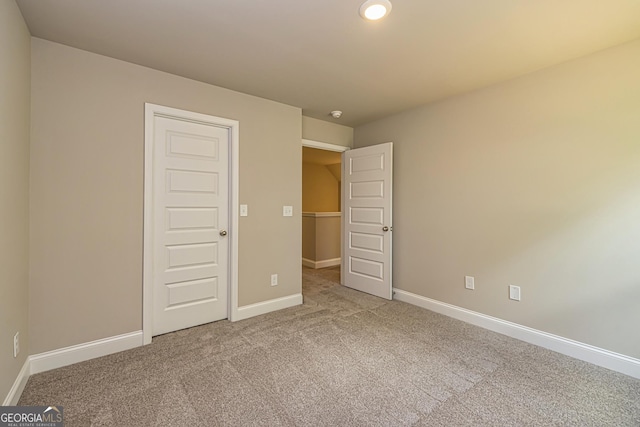 unfurnished bedroom featuring carpet flooring and a closet