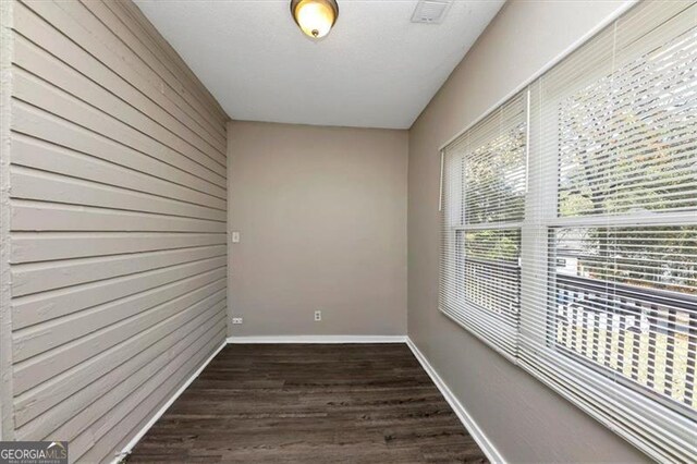 unfurnished room featuring dark hardwood / wood-style flooring