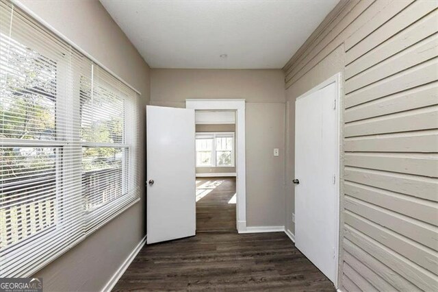 corridor with dark wood-type flooring