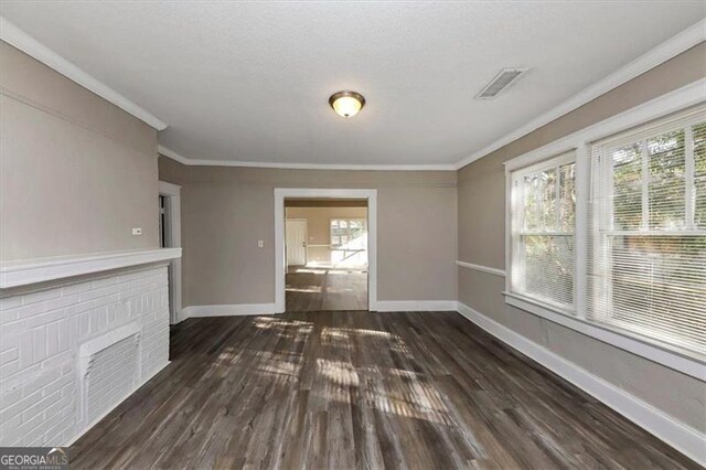 unfurnished living room featuring dark hardwood / wood-style floors and crown molding