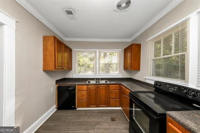 kitchen featuring black appliances, dark hardwood / wood-style floors, crown molding, and sink