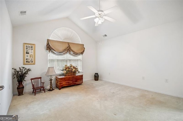 sitting room featuring ceiling fan, light colored carpet, and vaulted ceiling