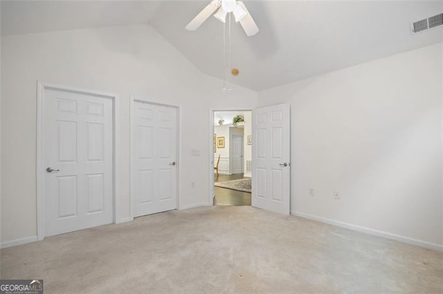 unfurnished bedroom featuring ceiling fan, light carpet, and high vaulted ceiling