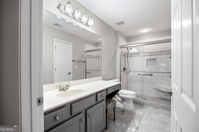 bathroom with toilet, vanity, and walk in shower