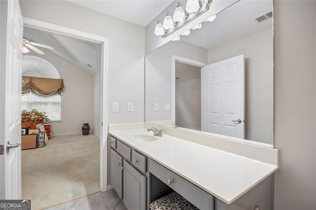 bathroom featuring vanity, vaulted ceiling, and ceiling fan