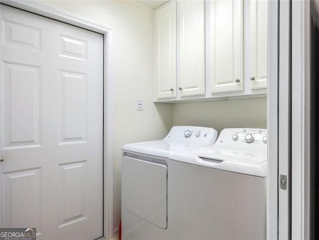 laundry area featuring cabinets and washing machine and clothes dryer