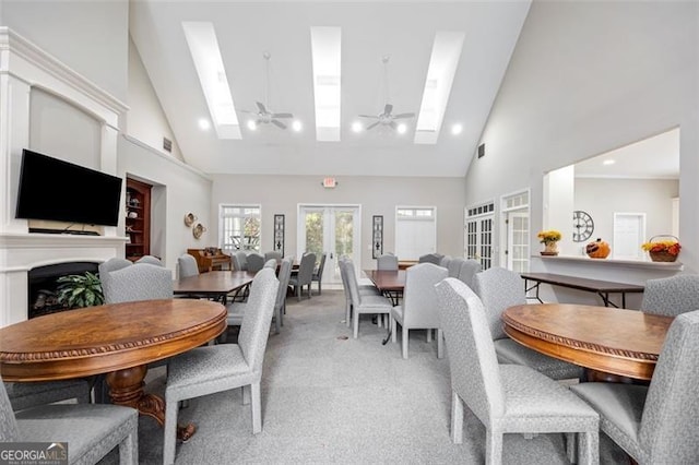 dining room with light carpet, french doors, high vaulted ceiling, and ceiling fan