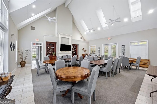 dining area featuring ceiling fan, high vaulted ceiling, and light tile patterned flooring