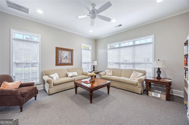 living room with ceiling fan, light carpet, and ornamental molding