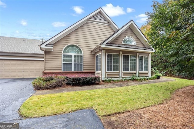 view of property with a front lawn and a garage