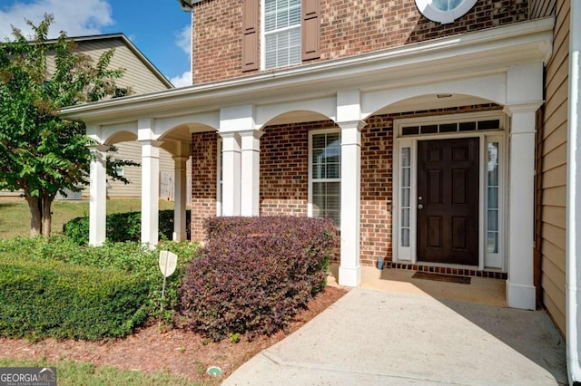 view of exterior entry featuring a porch