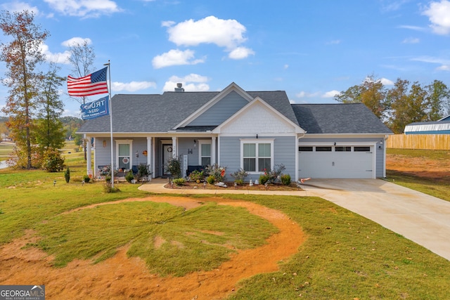 view of front of property featuring a front yard and a garage