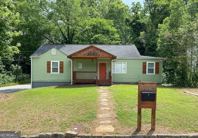 1204 Westridge Rd SW, Atlanta, GA 30311 - view of front facade with covered porch, a front lawn, and a shingled roof
