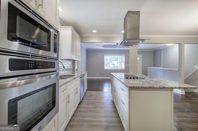 1204 Westridge Rd SW, Atlanta, GA 30311 - kitchen with appliances with stainless steel finishes, island exhaust hood, crown molding, a kitchen island, and baseboards