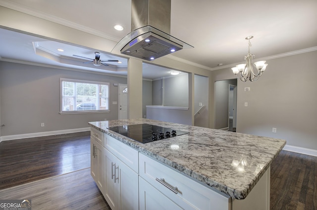 kitchen with island exhaust hood, white cabinetry, black electric stovetop, and light stone countertops