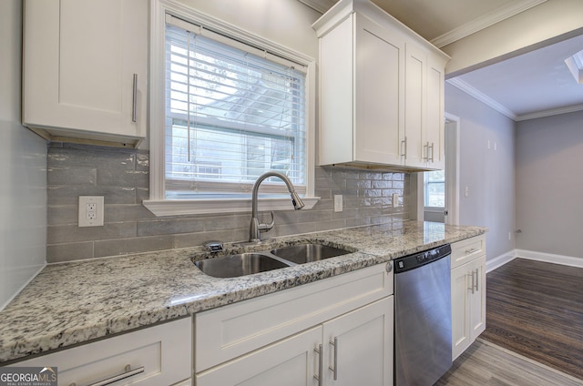 kitchen featuring dishwasher, white cabinets, sink, decorative backsplash, and wood-type flooring