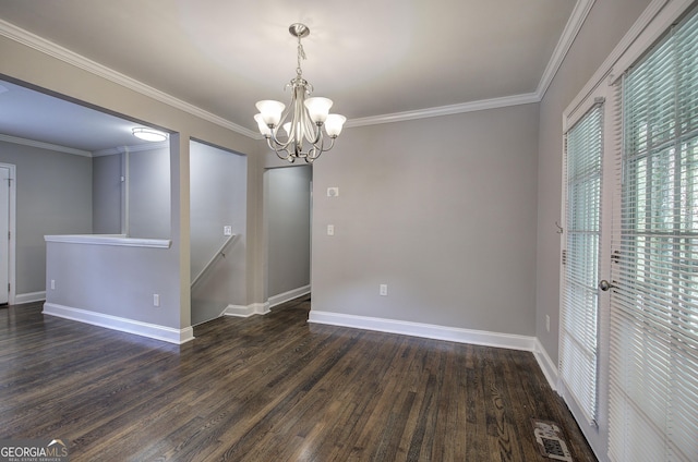 spare room with dark hardwood / wood-style flooring, ornamental molding, and an inviting chandelier