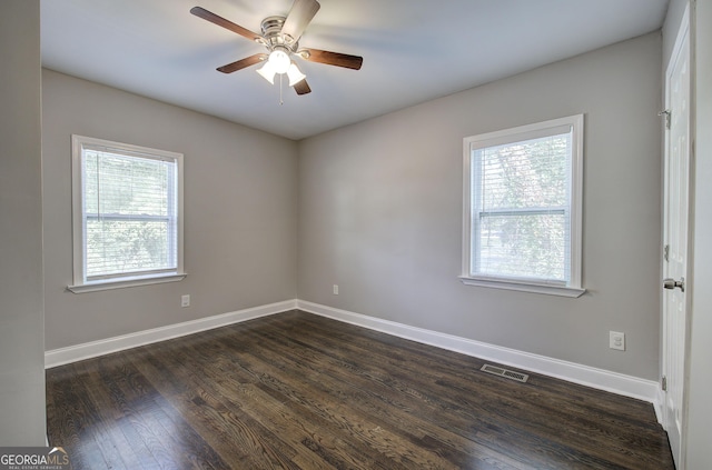 empty room featuring ceiling fan and dark wood-type flooring