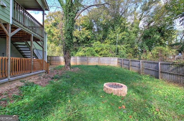 view of yard with a fire pit