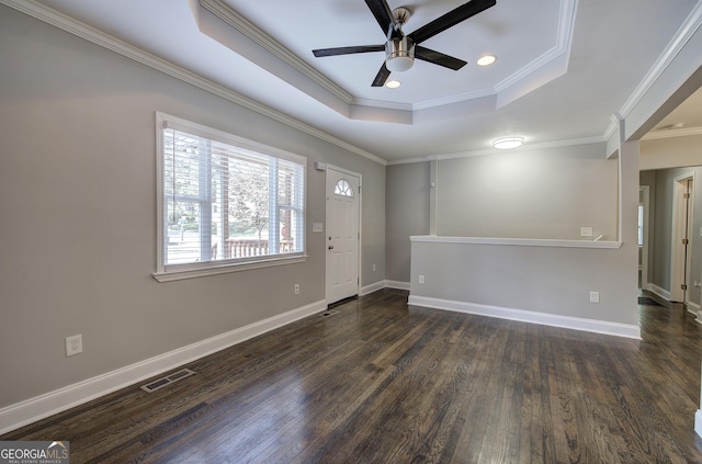 foyer featuring dark hardwood / wood-style flooring, a raised ceiling, ceiling fan, and crown molding