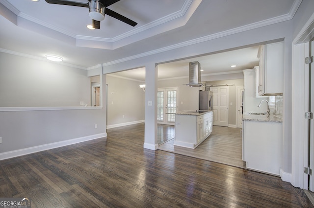 1204 Westridge Rd SW, Atlanta, GA 30311 - unfurnished living room with a sink, ceiling fan, a raised ceiling, dark wood finished floors, and crown molding