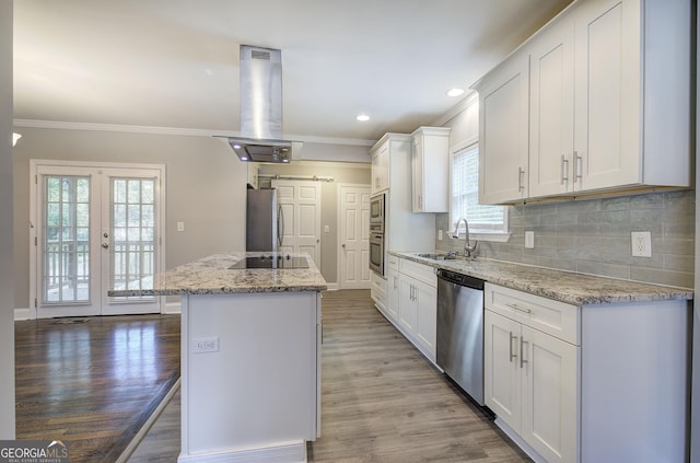 1204 Westridge Rd SW, Atlanta, GA 30311 - kitchen featuring stainless steel appliances, a sink, ornamental molding, white cabinets, and wood finished floors
