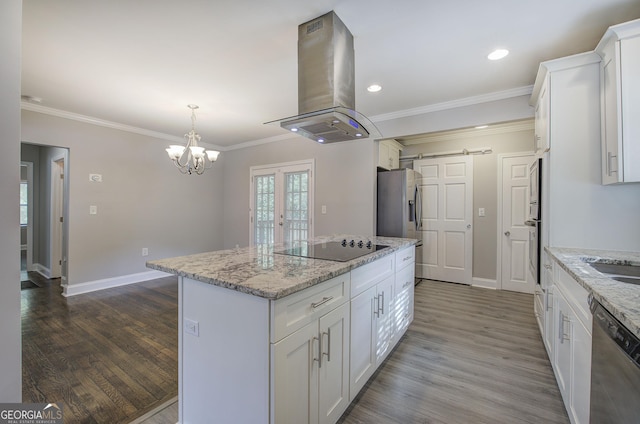 kitchen with island range hood, white cabinets, stainless steel appliances, and a kitchen island