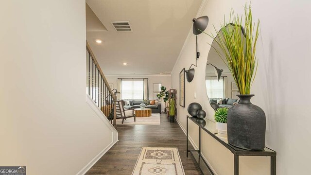 hall featuring dark hardwood / wood-style floors and crown molding